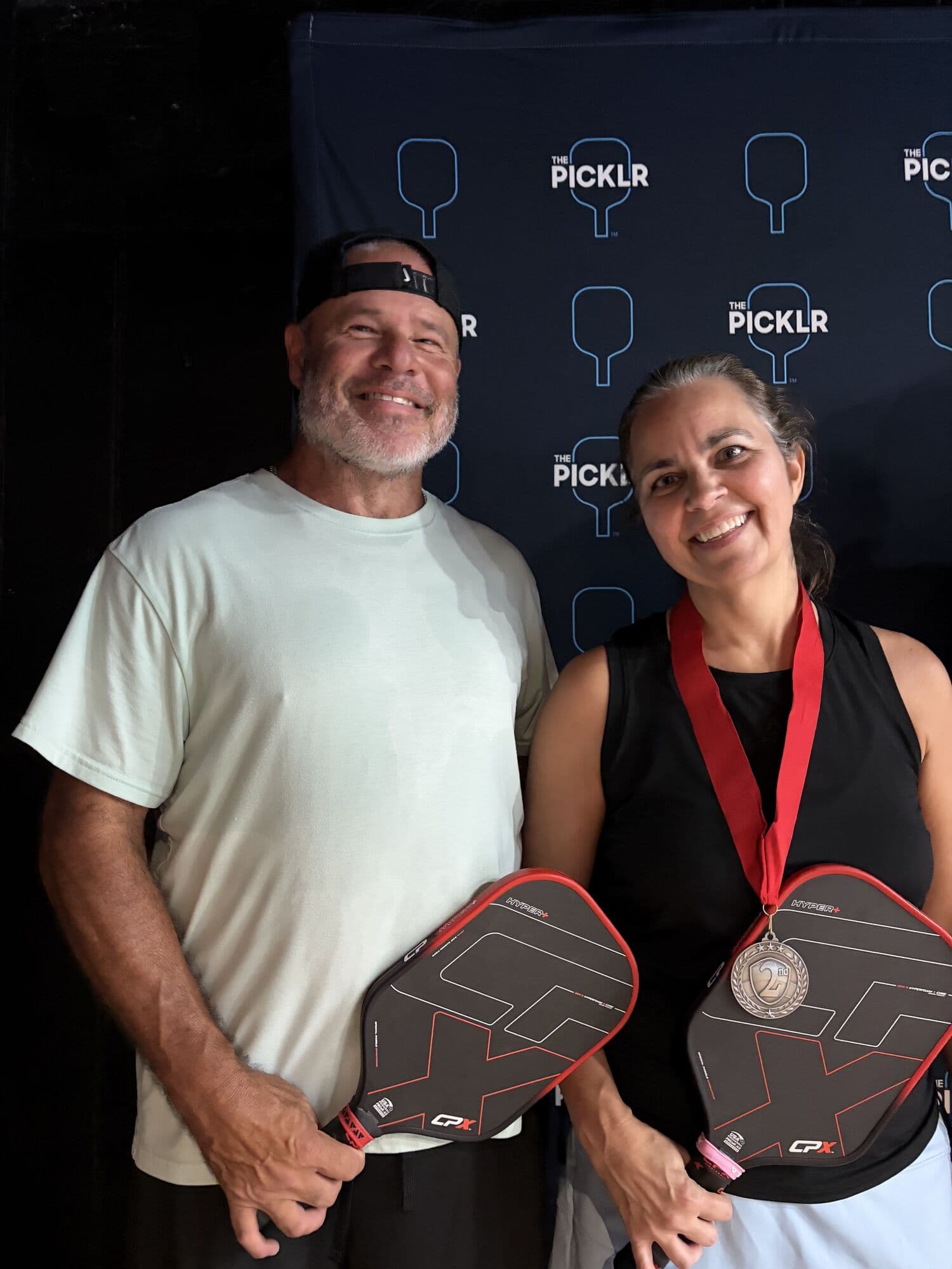 Mixed doubles medalists with their paddles and medals