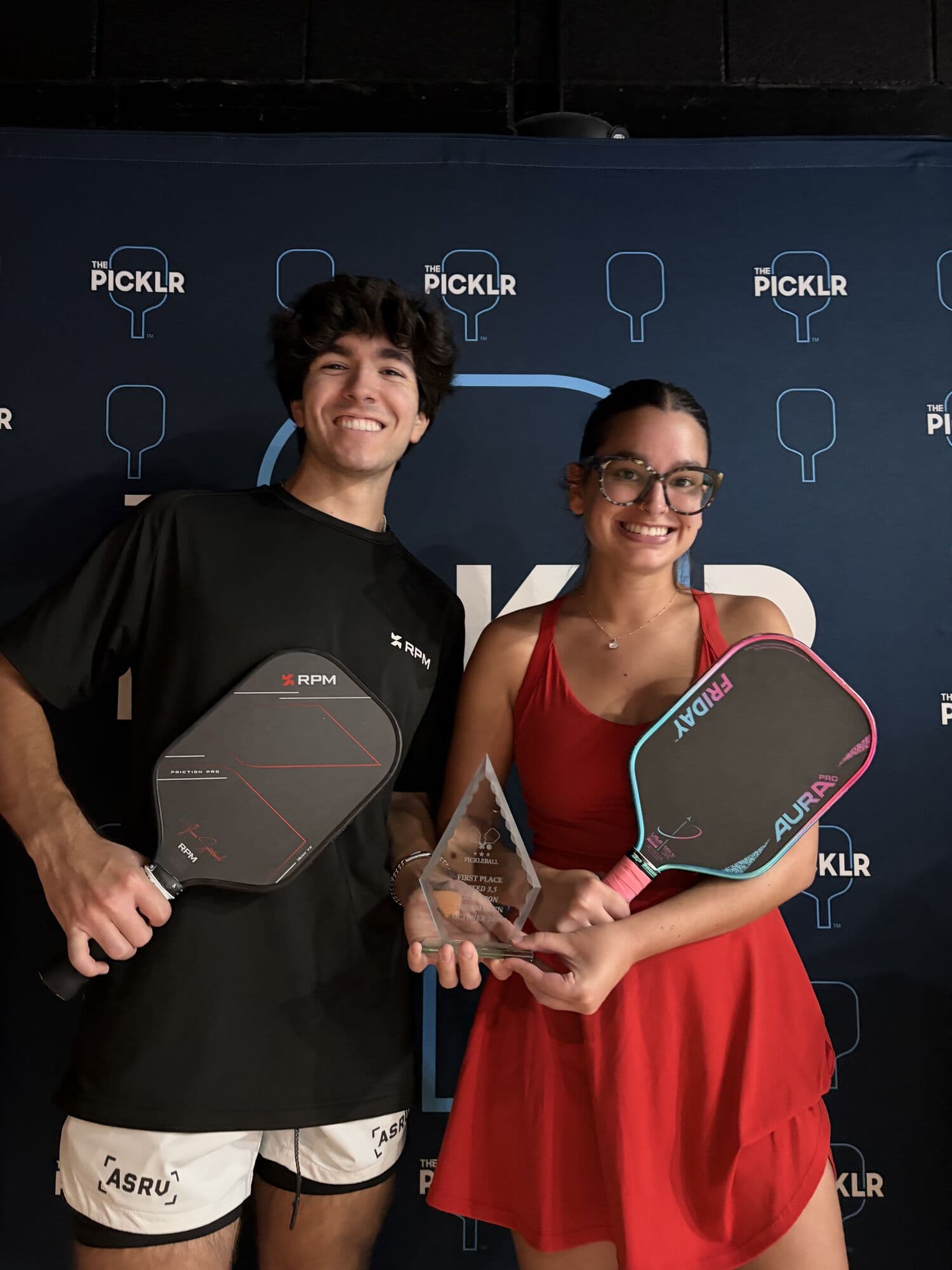 Mixed doubles medalists holding their trophy and paddles