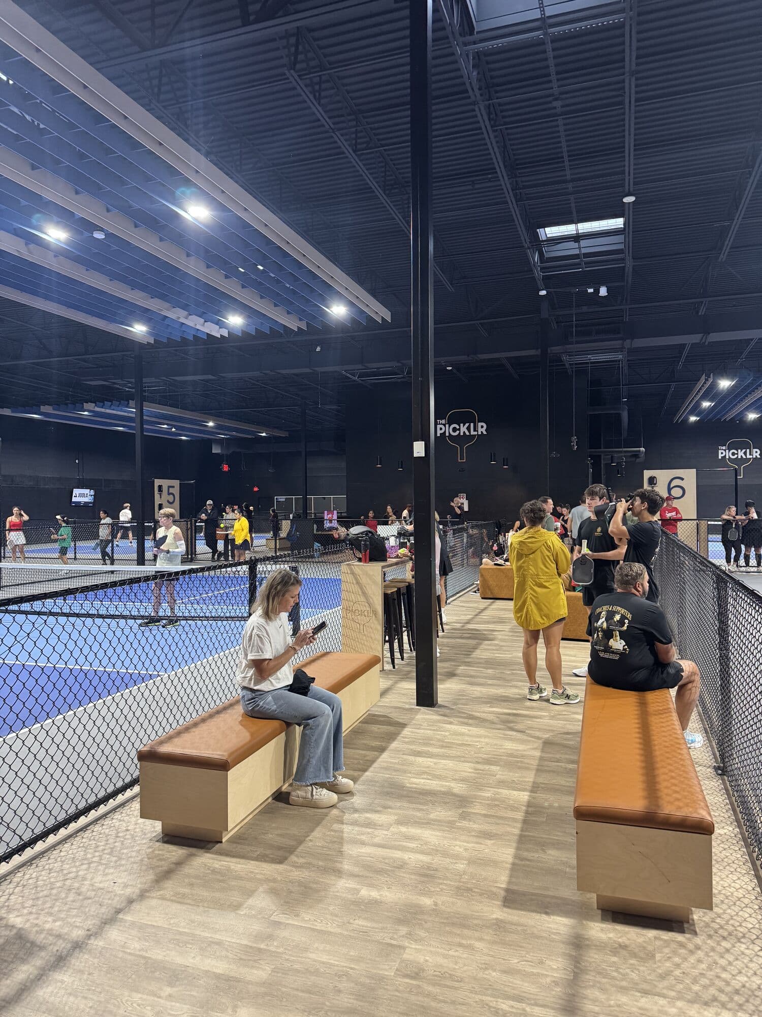 Players waiting courtside between matches on Saturday morning