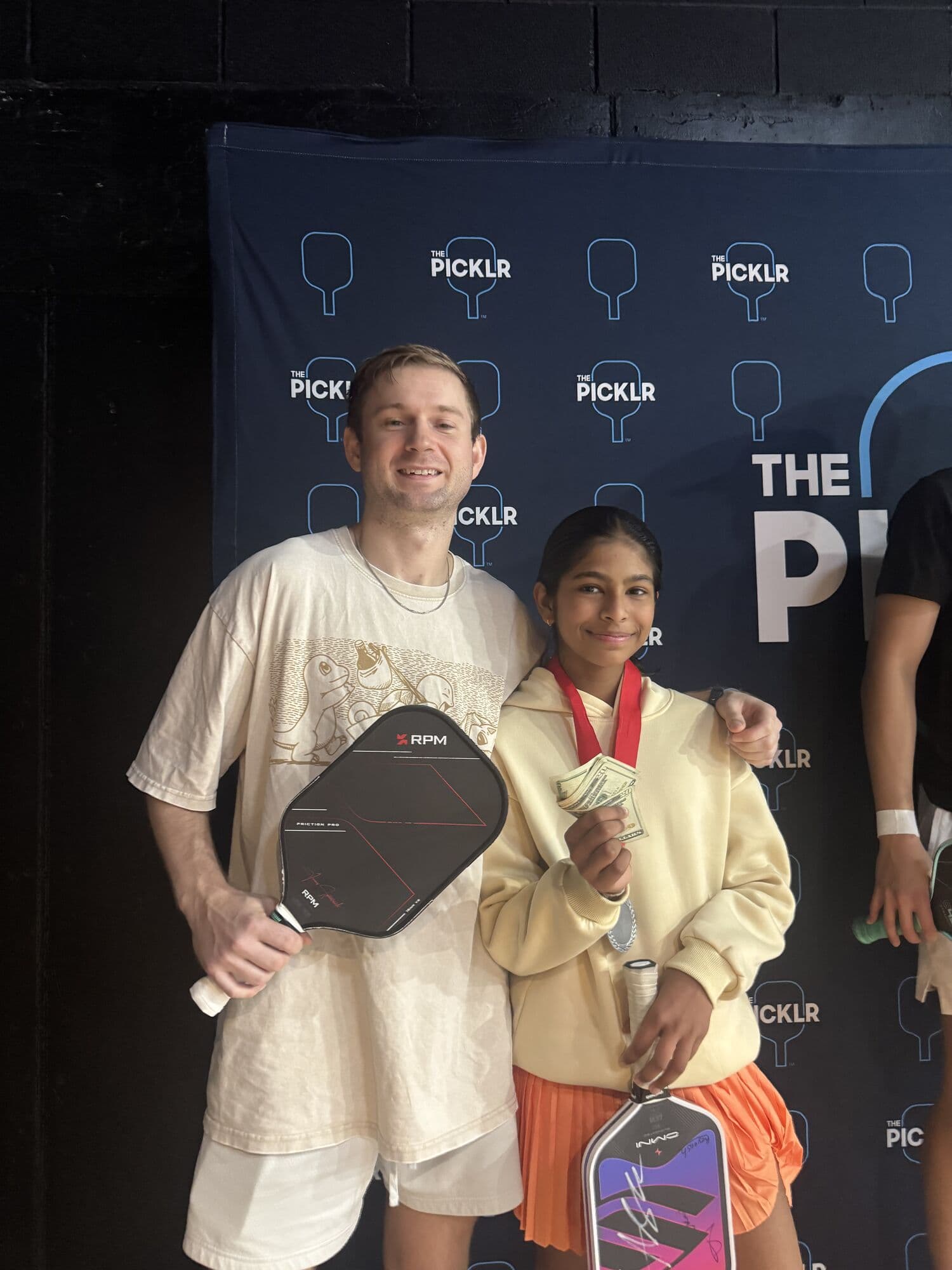 Mixed doubles medalists with their paddles and medals