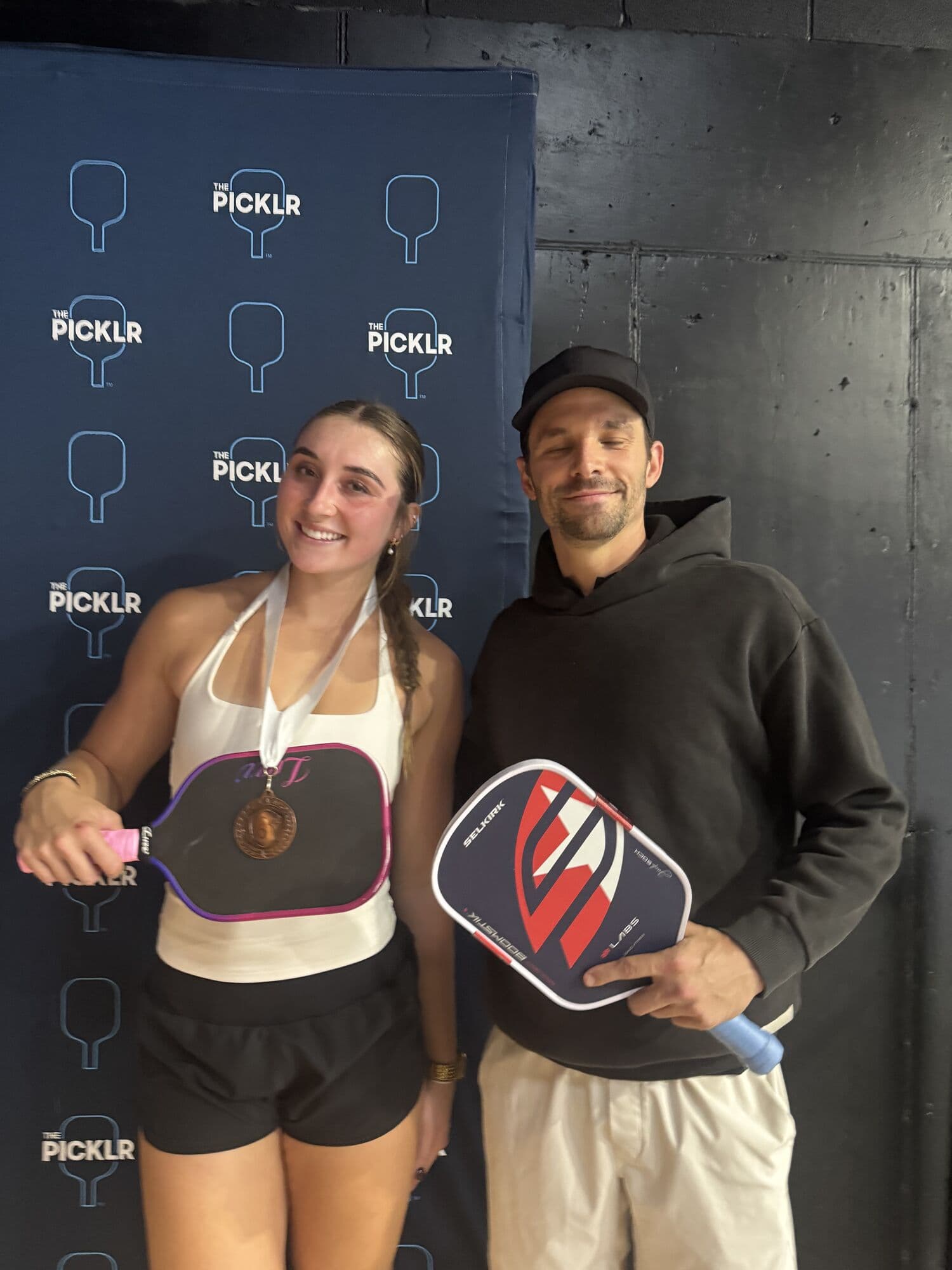 Mixed doubles medalists posing with their paddles