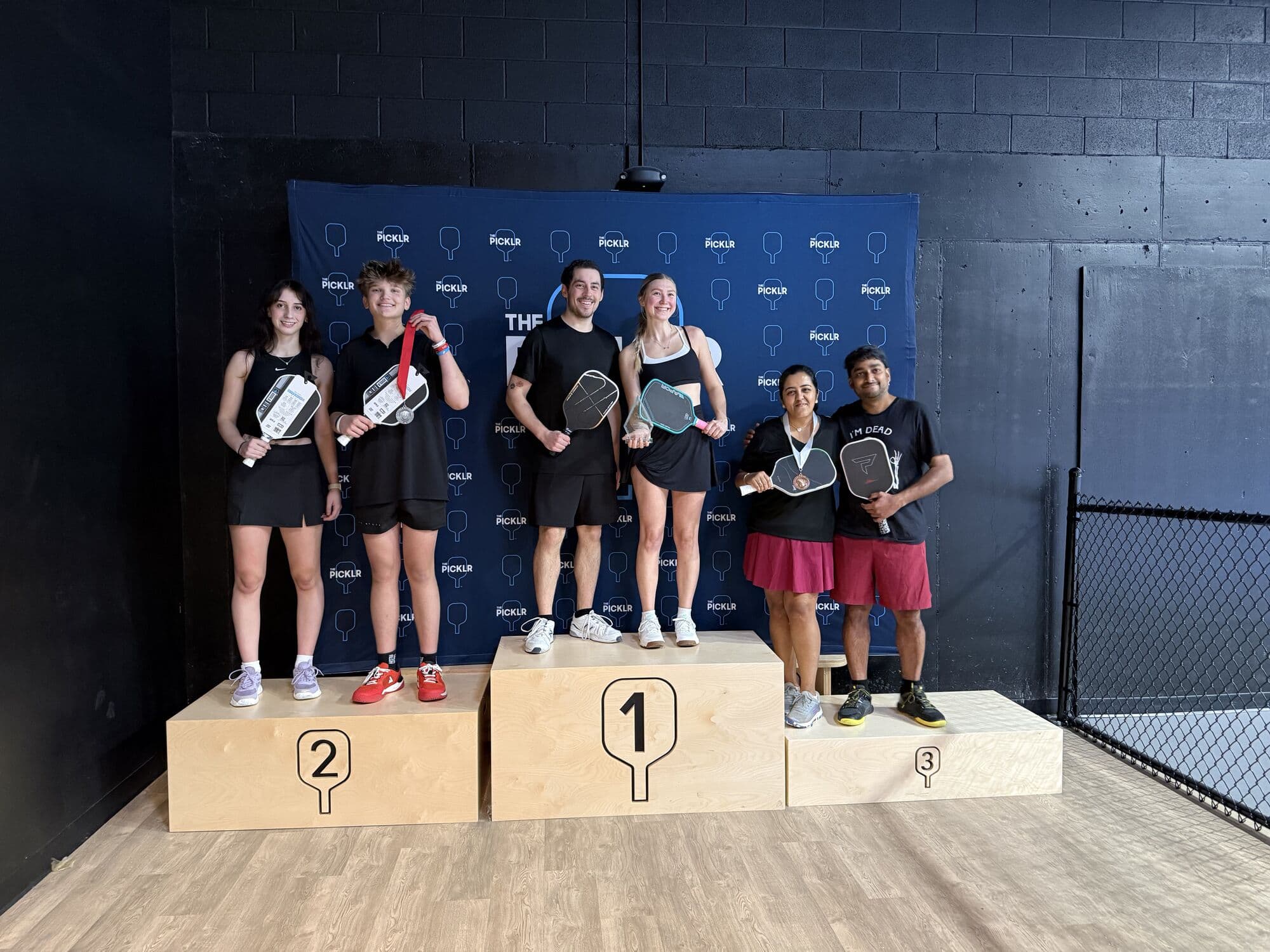 Mixed doubles medalists lined up across the podium